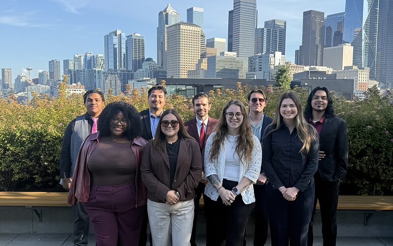 The Edge Marketing Agency team on a Seattle rooftop with the downtown skyline behind them